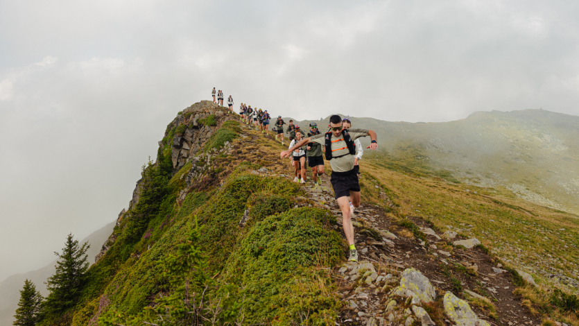 A group of trail runners on a mountain ridge
